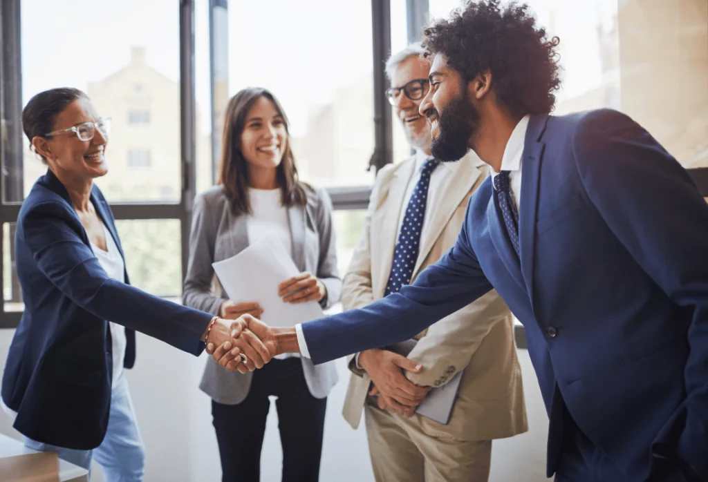 A sales rep shaking handing with a new prospect.