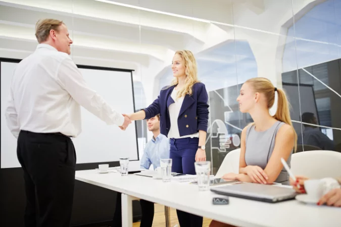 Two people shaking hands to show what you need to know about negotiating with professional buyers.