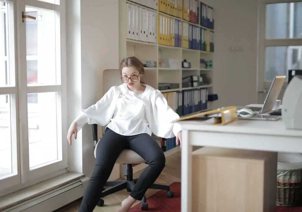 A woman sat in a office chair having behaviour leadership to understand the behaviour of employees. 