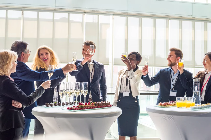 Office workers raising a toast on a company away day