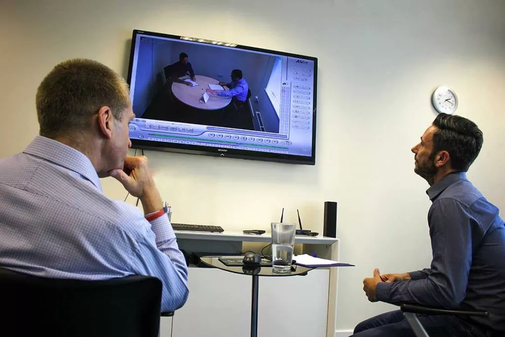 Two people looking at a TV screen